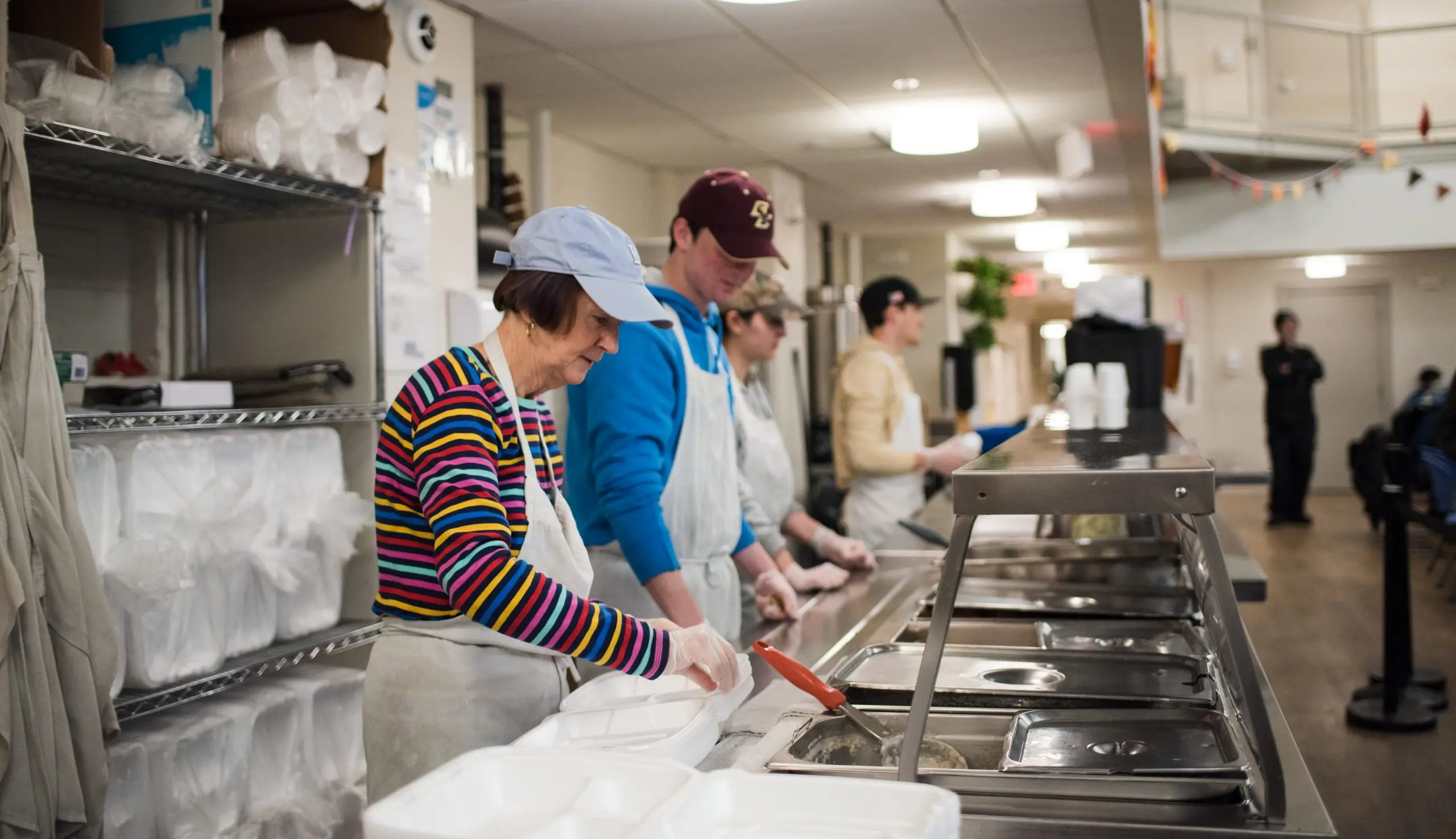 Volunteers serving lunch in the dining room