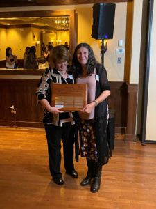 President and CEO Karen LaFrazia presents a plaque to Fabiana Videla in honor of her winning the Spirit of St. Francis Award.