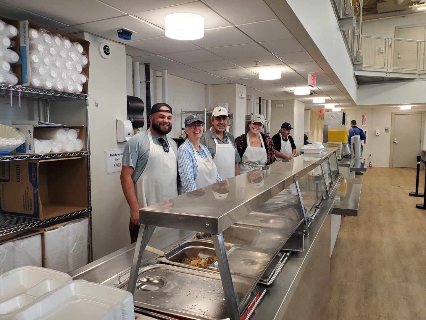 Volunteers behind the food line on the first day in the new shelter space.