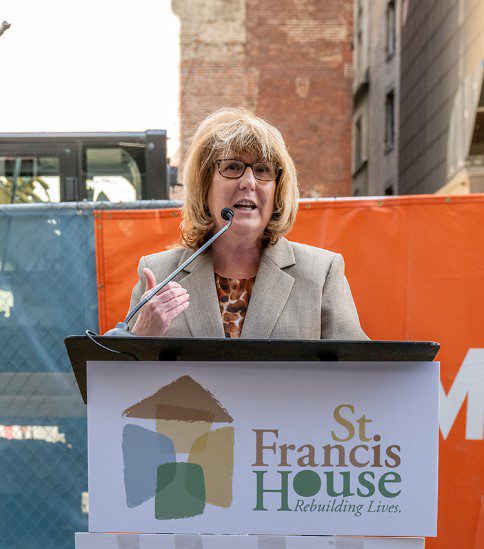 Karen LaFrazia standing at a lectern speaking