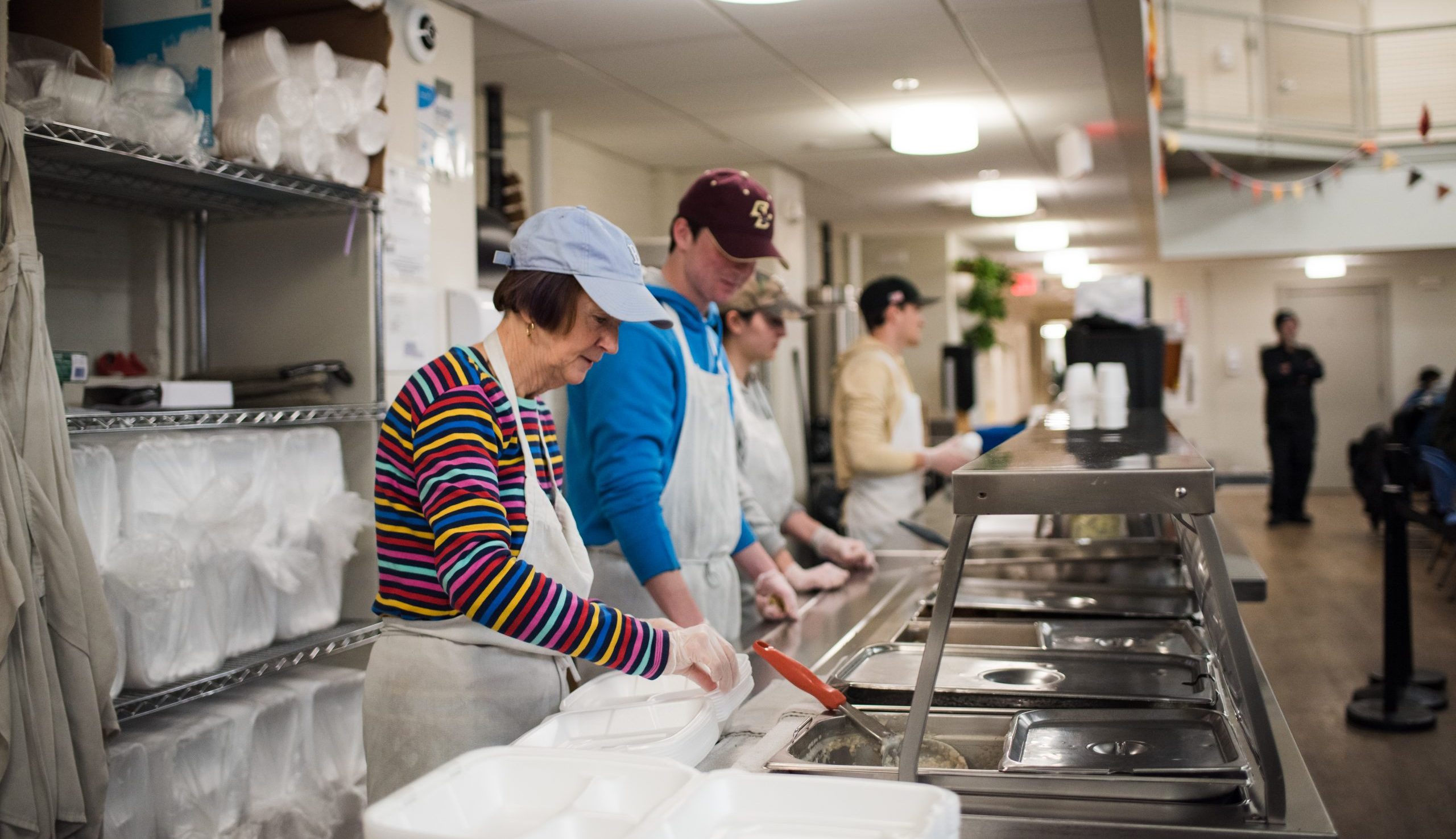 Volunteers serving lunch in the dining room